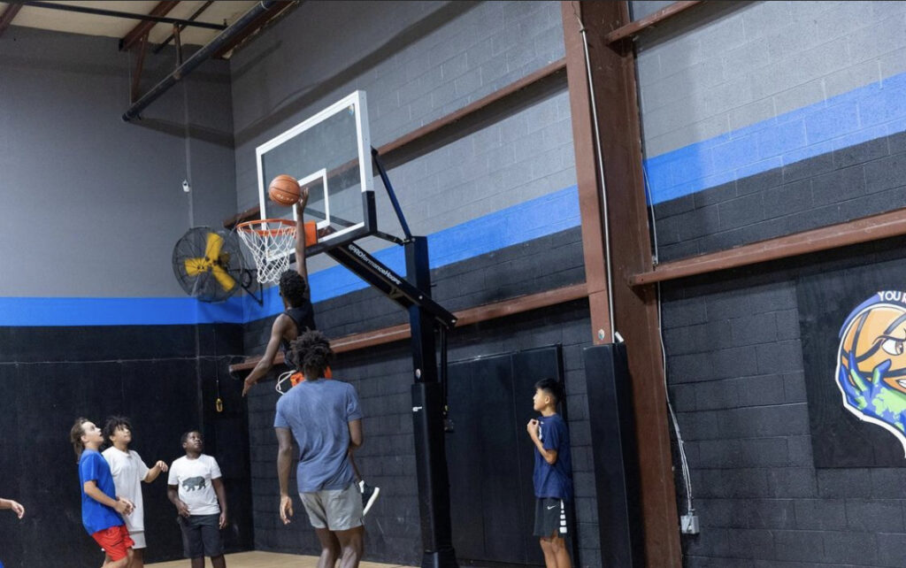 Players waiting their turn near the hoop during a shooting drill.