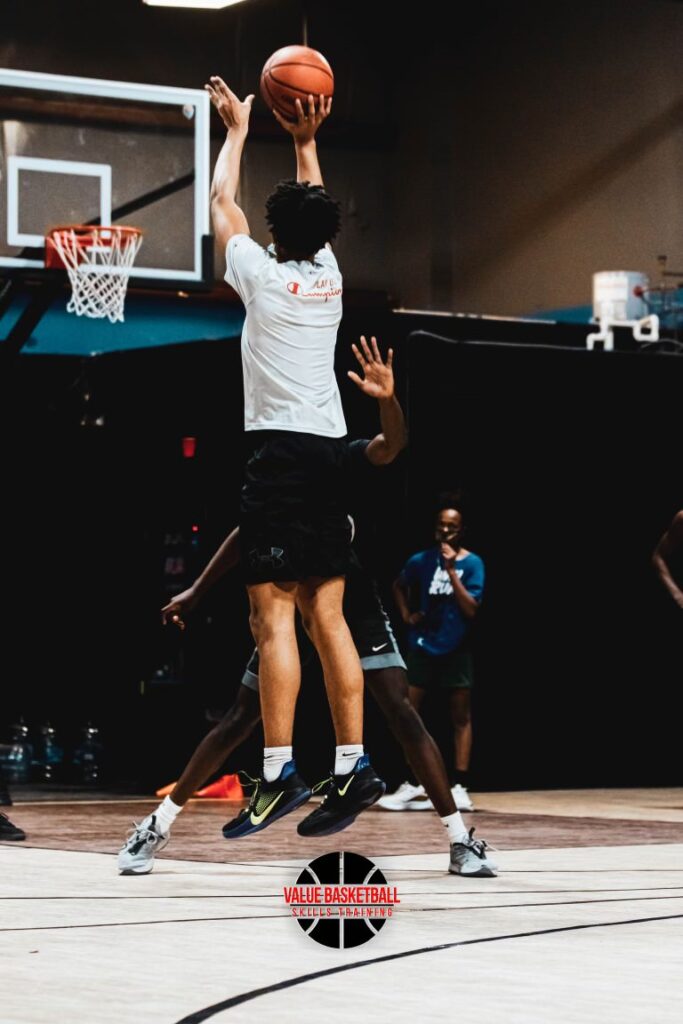 Player shooting a jump shot during a one-on-one defensive drill.