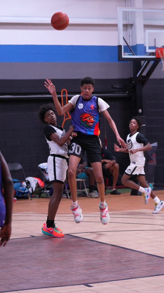Players jumping for a loose ball during a competitive game.